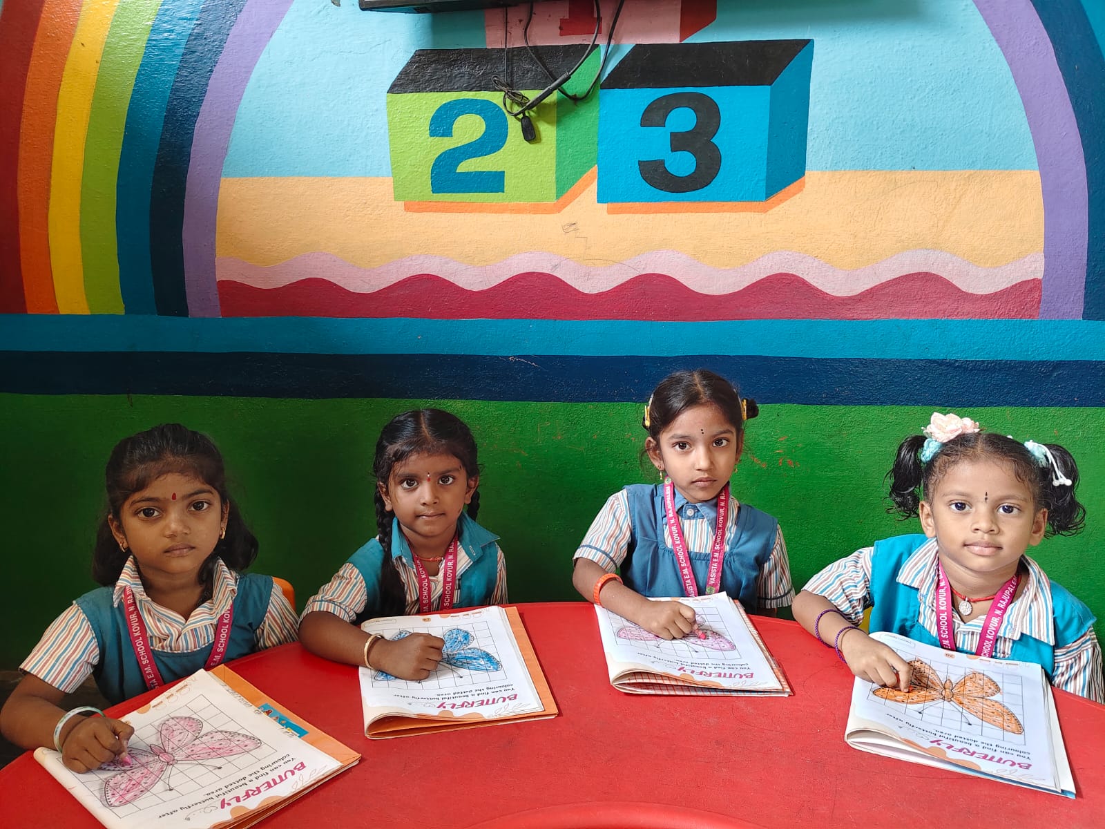 Vasista EM School students learning together in a colourful classroom